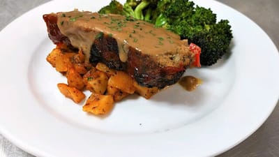 A plated meal with meatloaf, potatoes, and broccoli