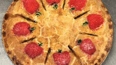 A pie topped with strawberries and colorful sugar