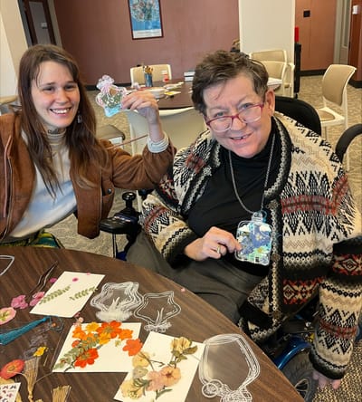 Residents engaged in a craft activity in the common area.