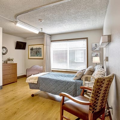 Bright and cozy resident room with a bed and sitting area