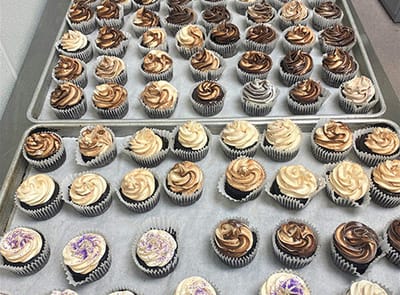Trays of decorated cupcakes ready for serving