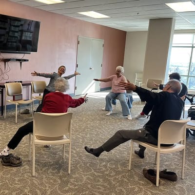 Residents participating in a seated exercise class