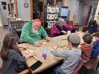 Residents and children baking together in a cozy activity room