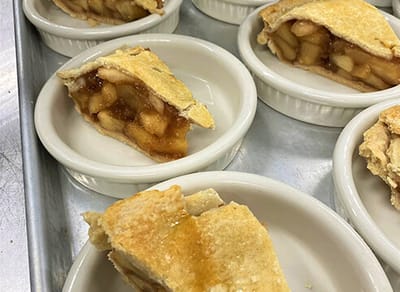 Individual servings of apple pie on a tray