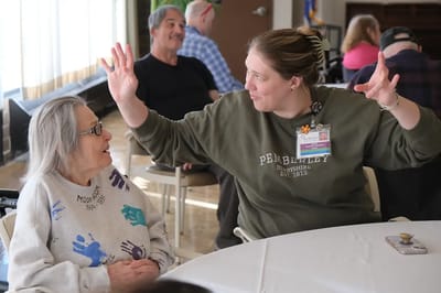 A staff member engaging with a resident during an activity