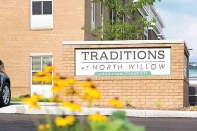 Signage for Traditions at North Willow in front of building