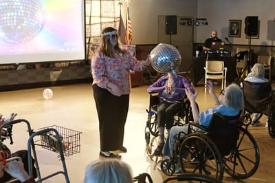 Residents enjoying a disco-themed activity in the common area