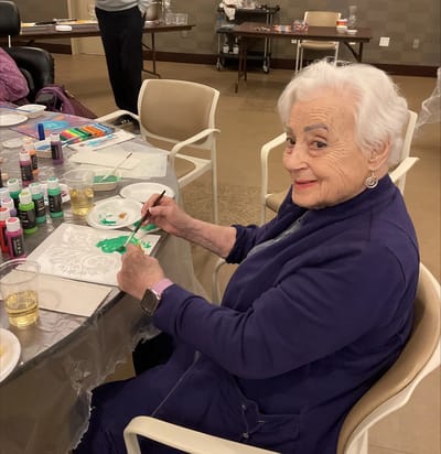Resident painting during an arts and crafts activity