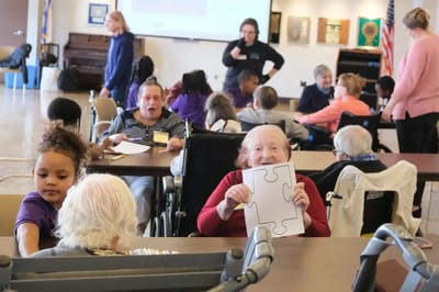 Residents and children engaged in an activity in a common area
