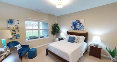 Cozy resident room with bed and personal touches