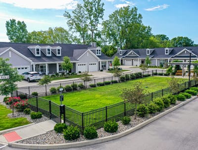 Aerial view of a senior living facility exterior with gardens