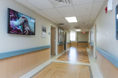 Interior hallway with a television and artwork