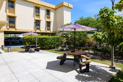 Outdoor seating area with tables and umbrellas