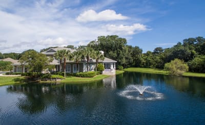 Exterior view of Osprey Village surrounded by water and greenery