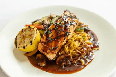 Grilled salmon with vegetables and noodles on a plate