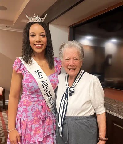 Resident and Miss Albuquerque in a common area