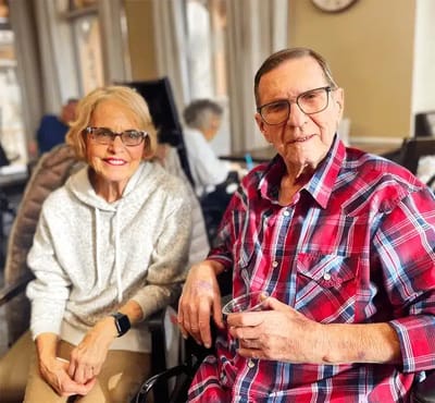 Two residents smiling in a common area