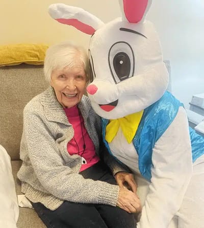Resident enjoying time with an Easter Bunny character