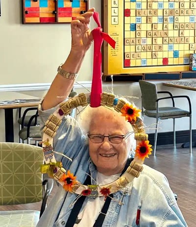 Resident holding a decorated wreath during an activity