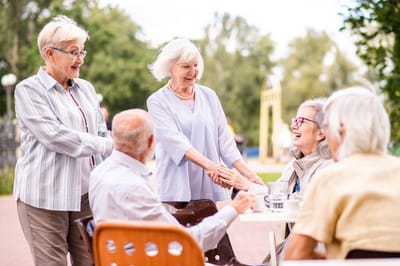 Seniors engaging in conversation outdoors