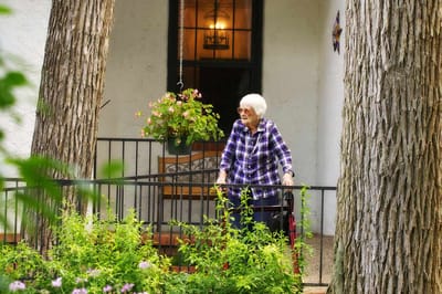 Resident enjoying the outdoors near the entrance.