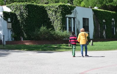 Two individuals walking outside the facility
