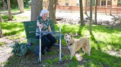 Senior resident with a dog in outdoor space