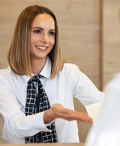 Receptionist assisting a visitor