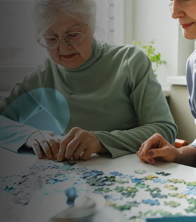 Residents working on a puzzle together.