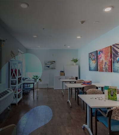 Common area with tables and artwork on the walls.