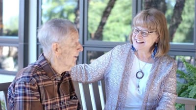 Resident and staff member enjoying a conversation.