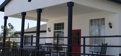 Exterior view of a facility entrance with a red door