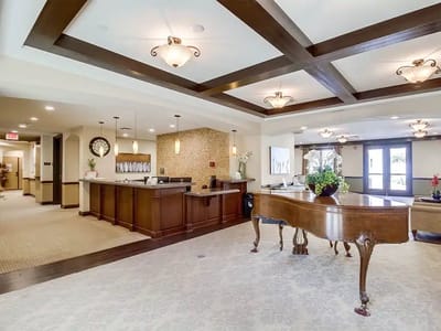 Elegant lobby area with a piano and reception desk