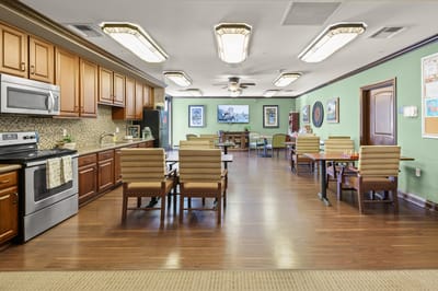Cozy assisted living common area with seating and kitchen