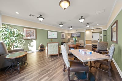 Common area with seating and plants in the background.