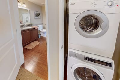 Laundry area with washer and bathroom visible