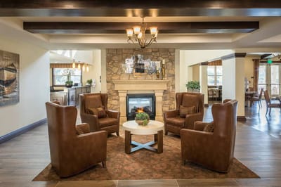 Cozy common area with armchairs and a fireplace