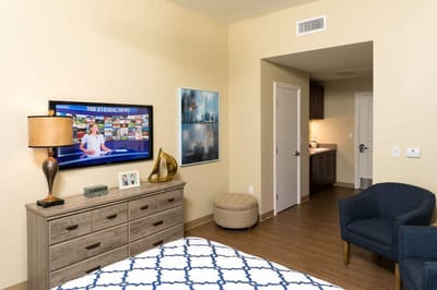 Cozy resident room with a television and dresser