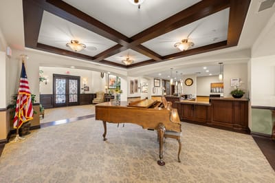 Bright interior lobby with piano and American flag