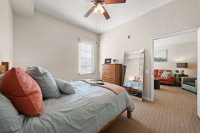 Cozy interior of a resident room with a bed and seating area