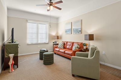 Cozy living room area with orange sofa and artwork