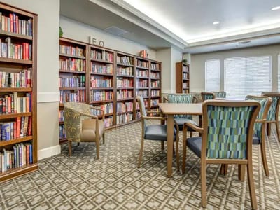 Cozy interior common area with bookshelves and seating