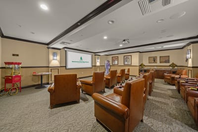 Cozy common area with seating and a projector screen