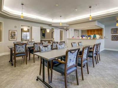 Bright and spacious common area with chairs and tables