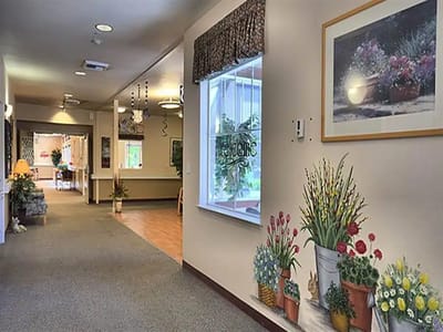 Interior hallway with floral decorations and a welcoming sign