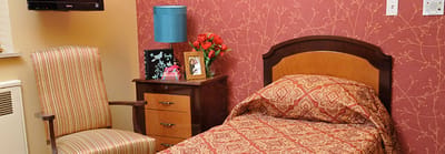 Cozy private resident room with patterned bedding