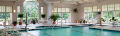 Indoor pool area with seating and large windows