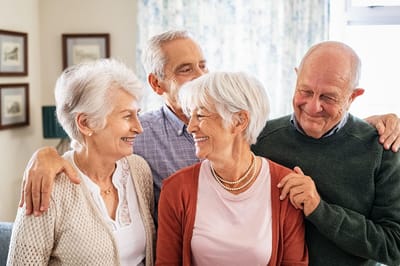 Four seniors enjoying a moment together indoors