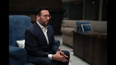 A man sitting in a lounge area.