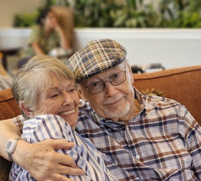 Senior couple enjoying each other's company in a common area.